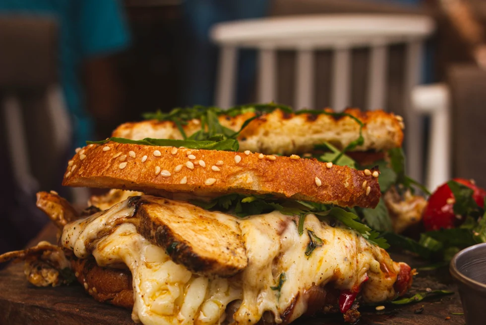 Sandwich with cheese on a wooden plate