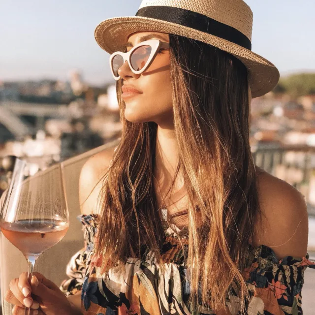 Travel advisor posing with a glass of wine