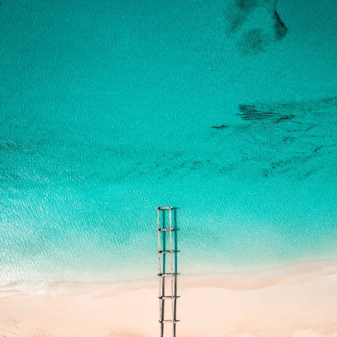 An azure blue sea and white-sand beach. 