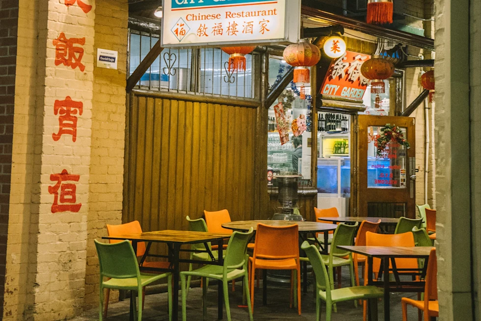 orange and chairs next to wall with white sign