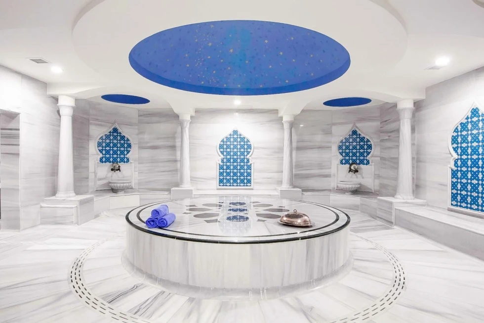 Inside of a mosque with white and blue interior.