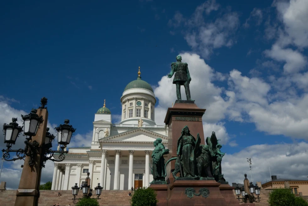 white building with stairs and many bronze statues