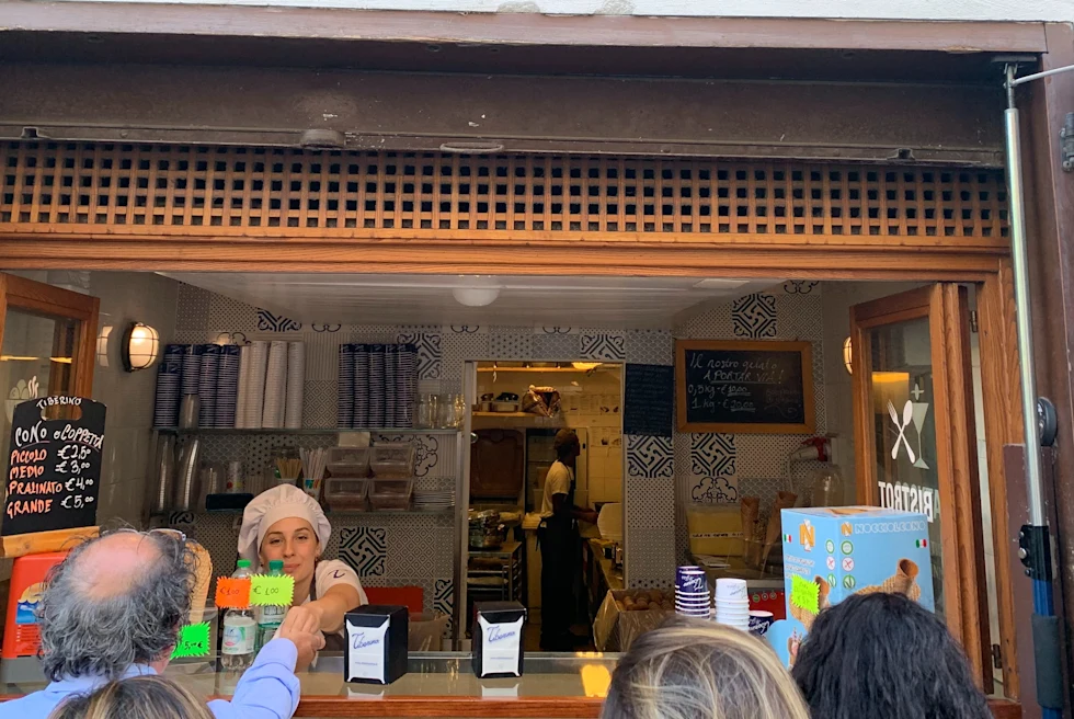 people standing next to a window during daytime