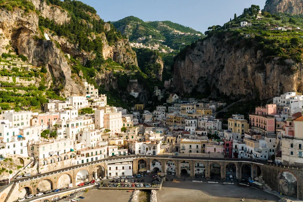Buildings with mountains at the back.