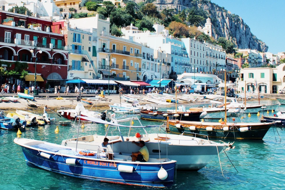 Capri port featuring traditional buildings and boats. 