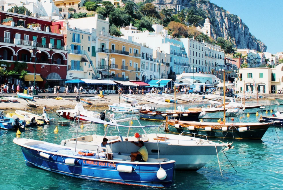 Capri port featuring traditional buildings and boats. 