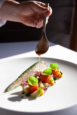 A gourmet dish being plated in Switzerland. 