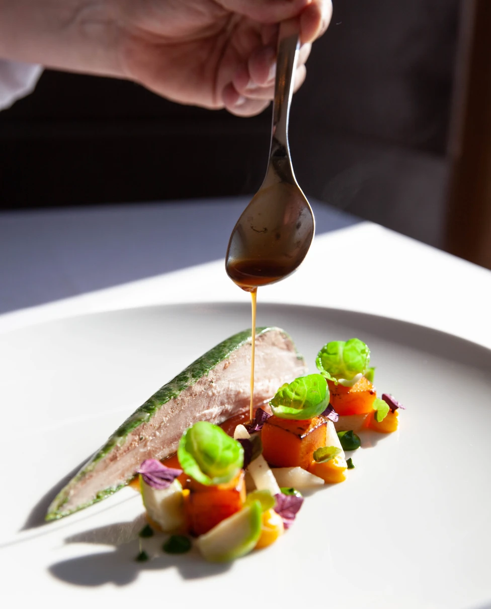 A gourmet dish being plated in Switzerland. 