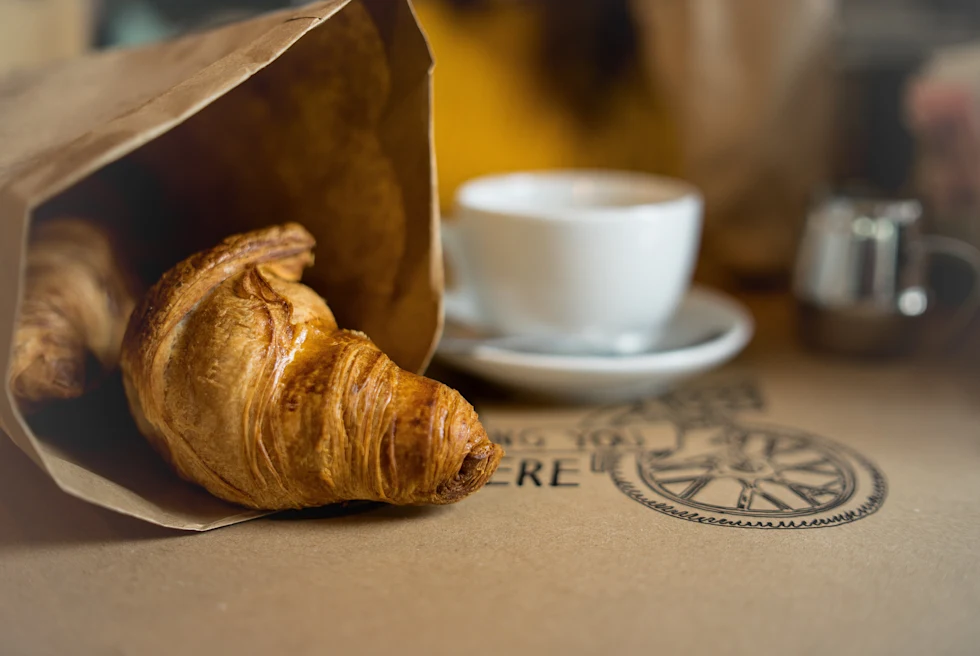 croissant and cup of coffee on table