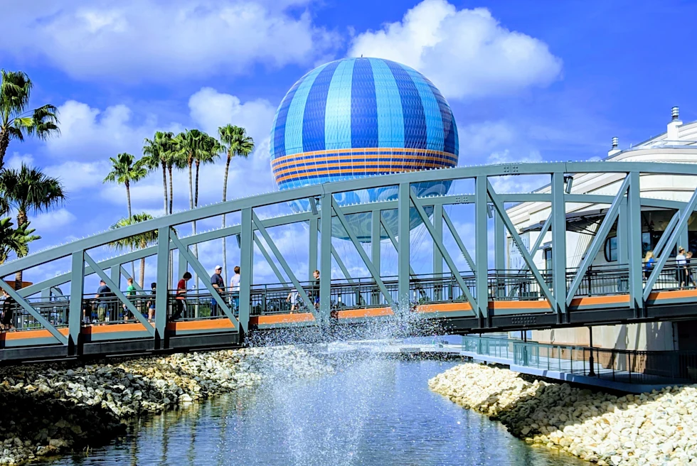 Fountain with bridge and large building during daytime