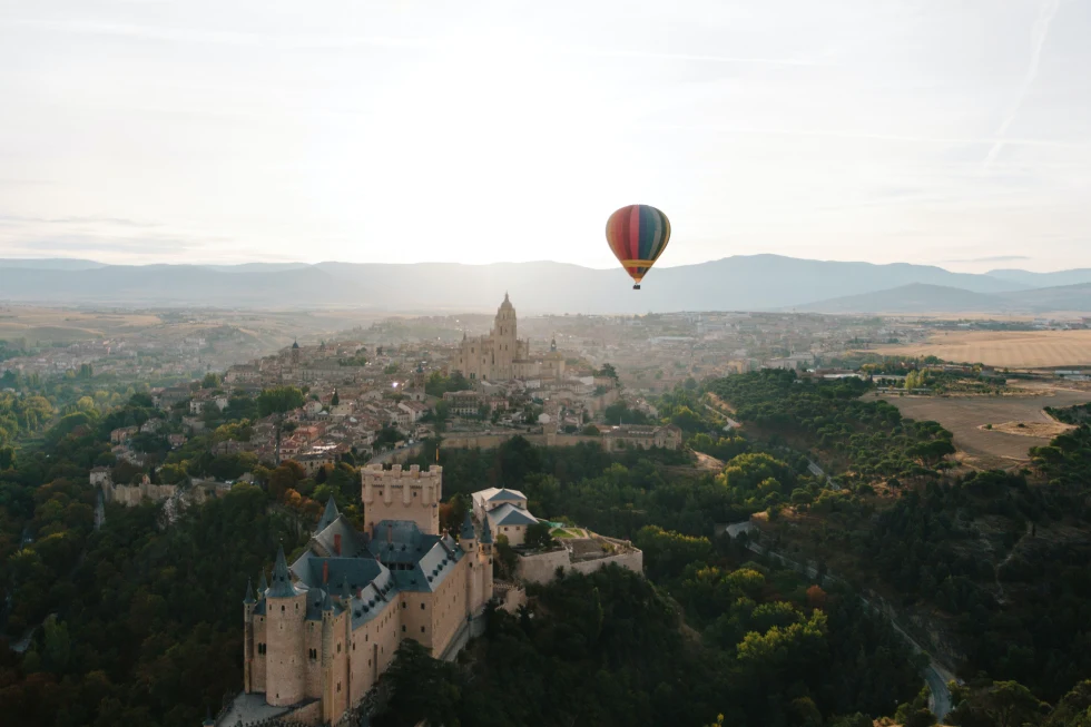 colorful air balloon over land and buildings