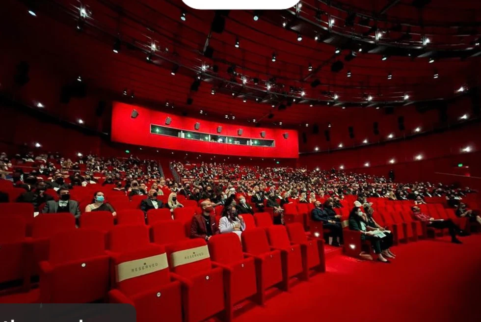 room filled with red seats and red carpet