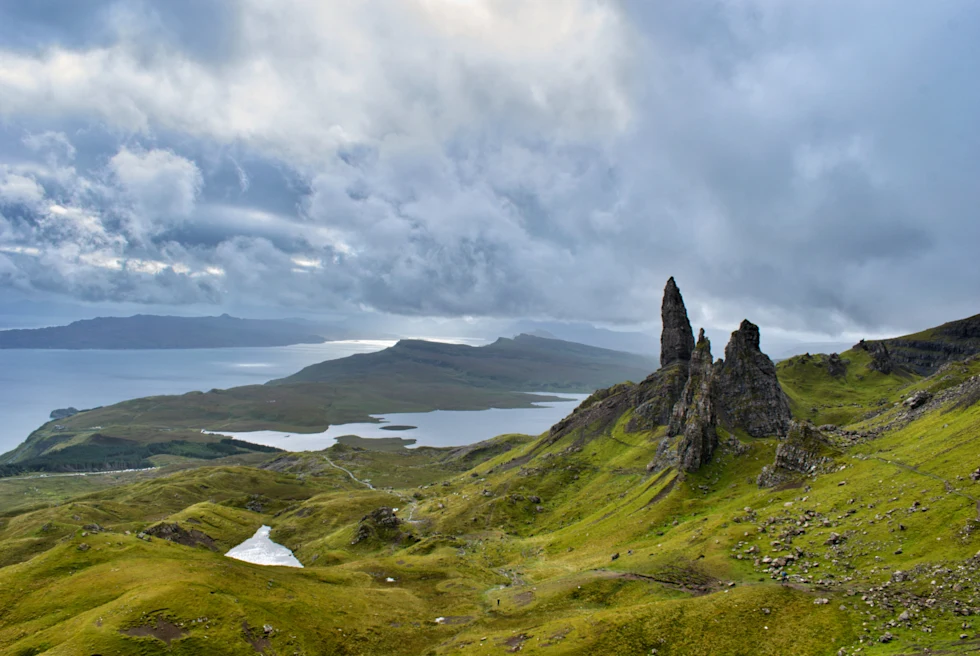 large rock formations with a body of water in the distance