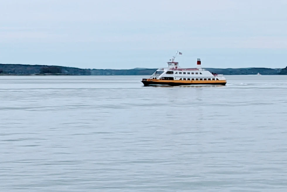 White boat in body of water with cloudy skies during daytime