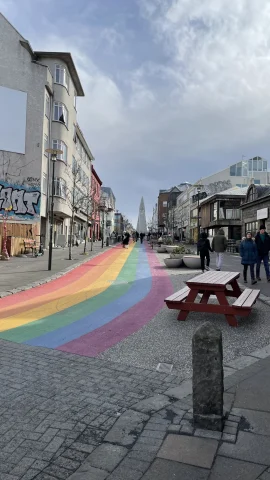 A street with a rainbow painted on the road during the daytime