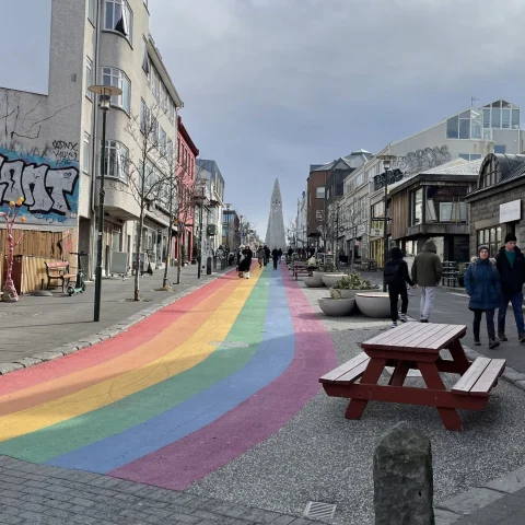 A street with a rainbow painted on the road during the daytime