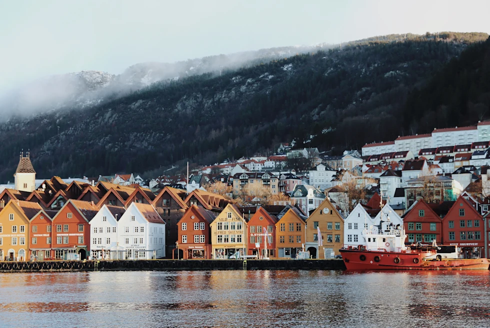 The colorful city of Bergen, Norway with houses standing on the fjord.