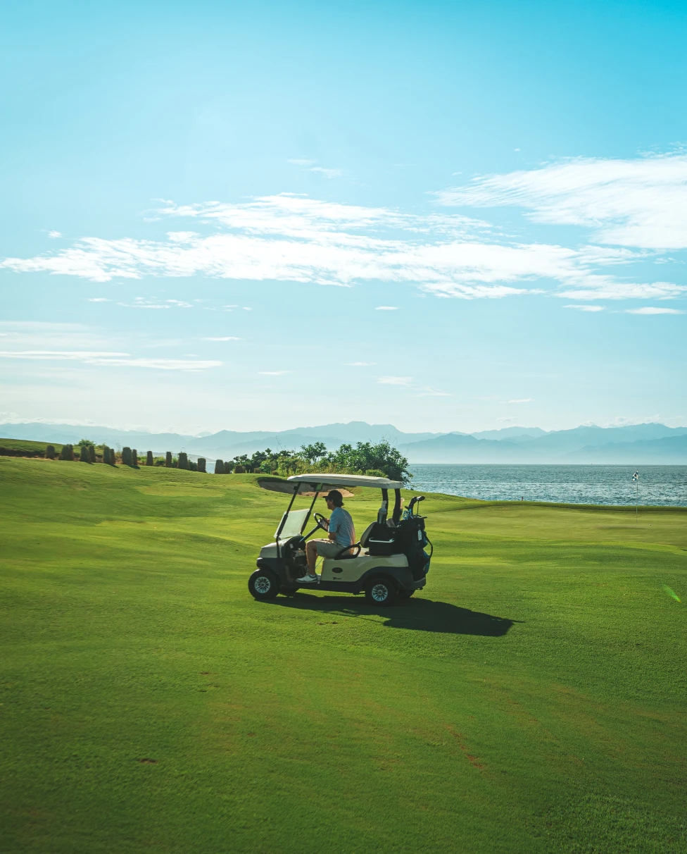 A golf cart on a green golf course in Punta Mita. 