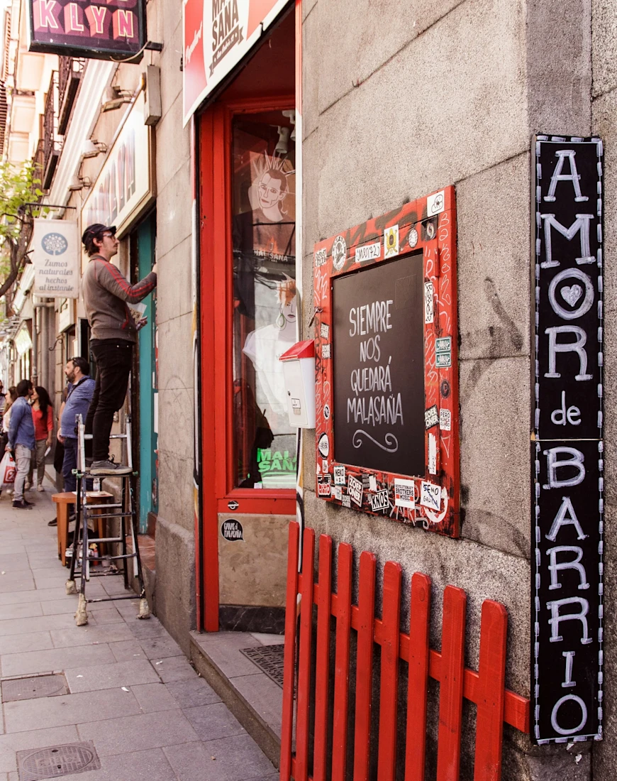 a man stands on a stool on an urban street