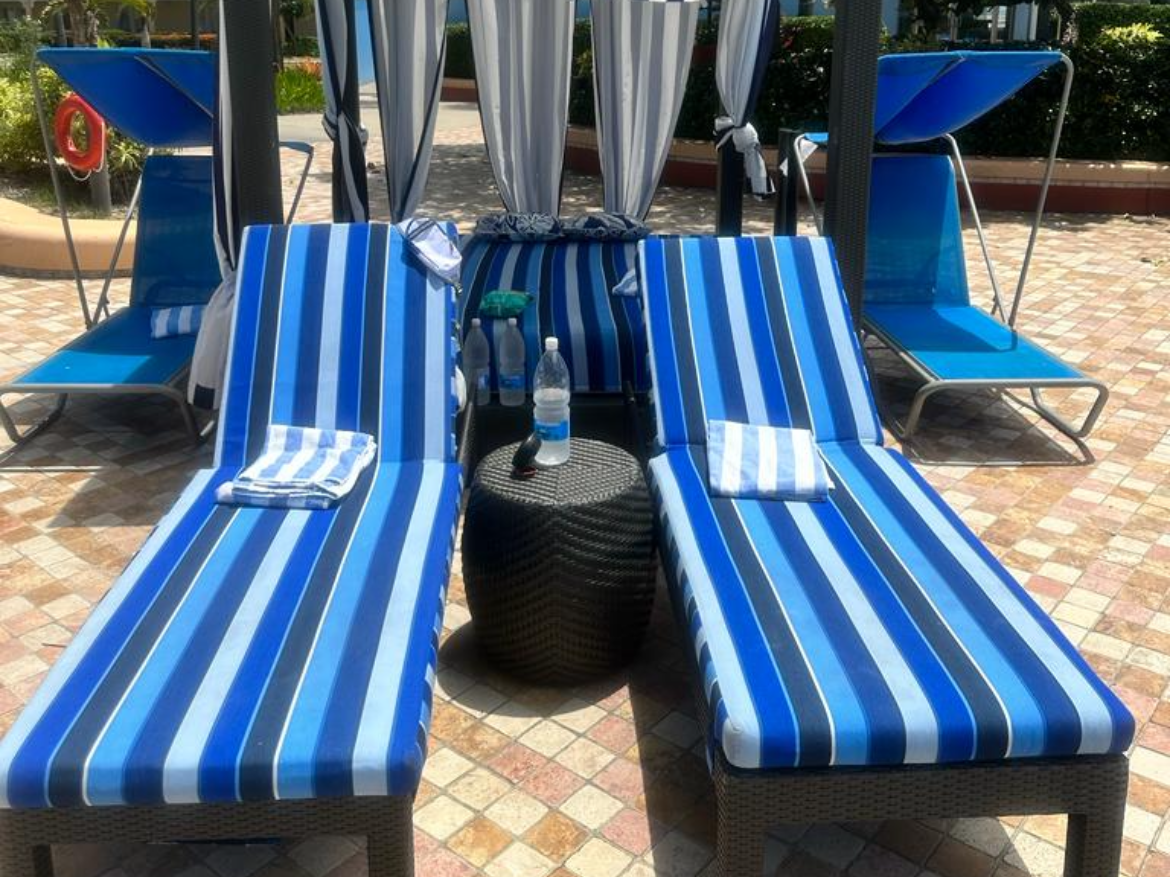 Two blue sun loungers sitting side-by-side outside