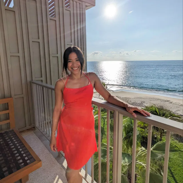 Travel Advisor Princess Sambilay posing on a terrace in red dress
