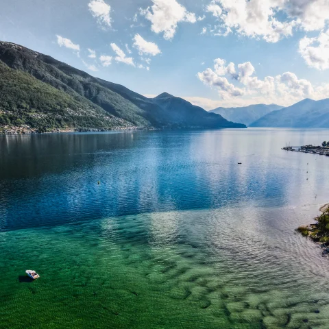 Lake Maggiore surrounded by mountains.