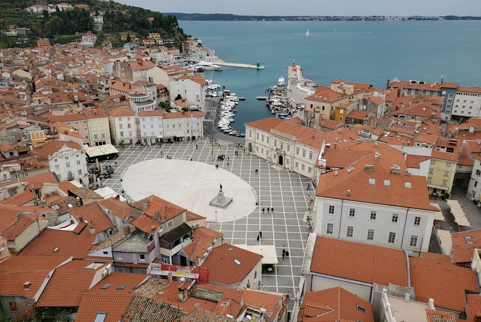 Aerial view of a walkway in between buildings close to a body of water during daytime