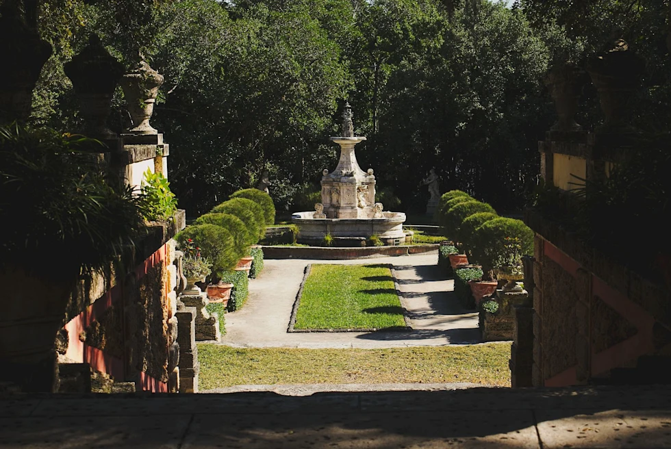 shadows and sun shines through to garden courtyard with fountain