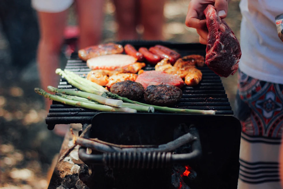 A backyard bbq with meat and veggies.