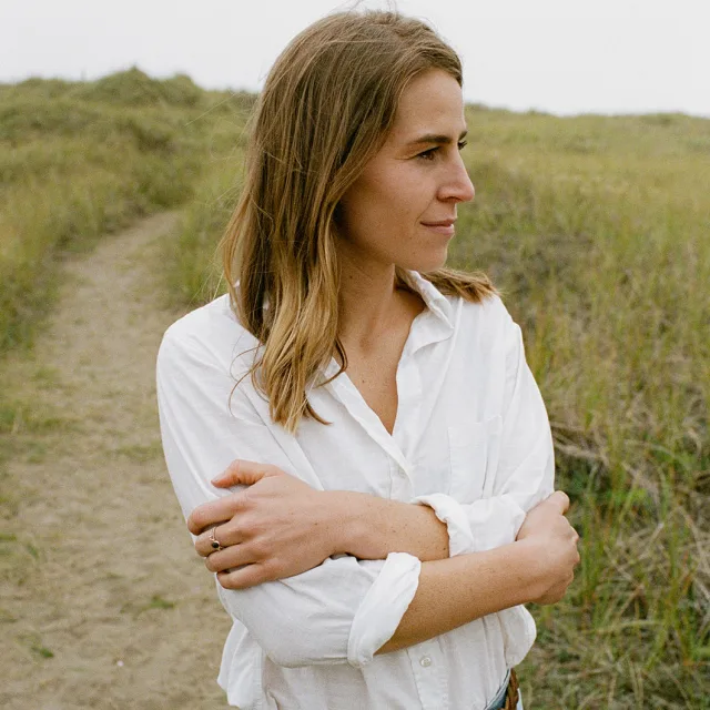 Fora travel agent Bobbilee Hartman wearing a white shirt with grass in background