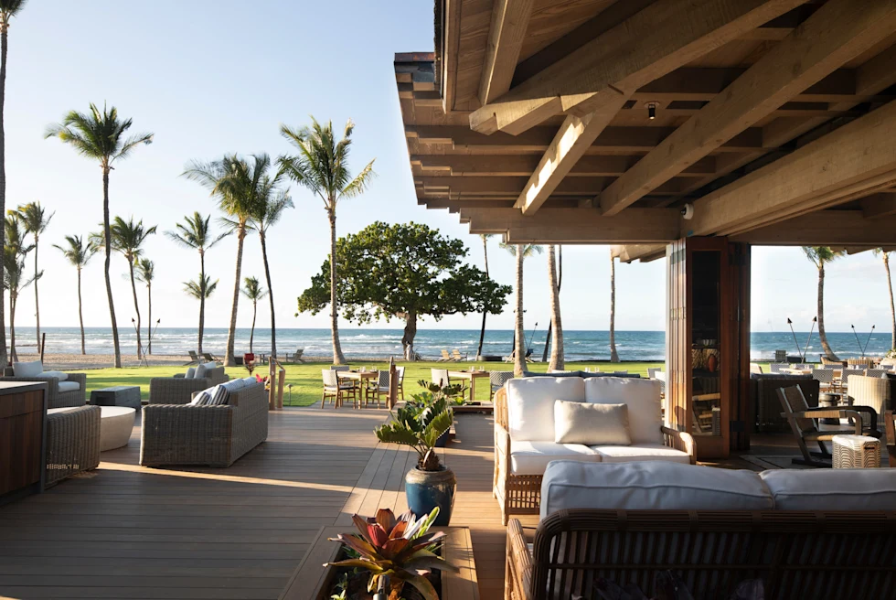 large patio with outdoor furniture and palm trees