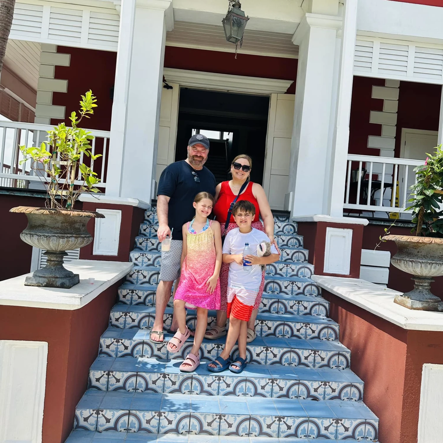 Travel advisor posing with family standing on entrance stairs