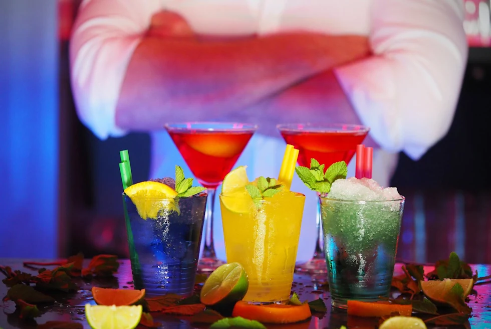 Three glasses with colorful margaritas.