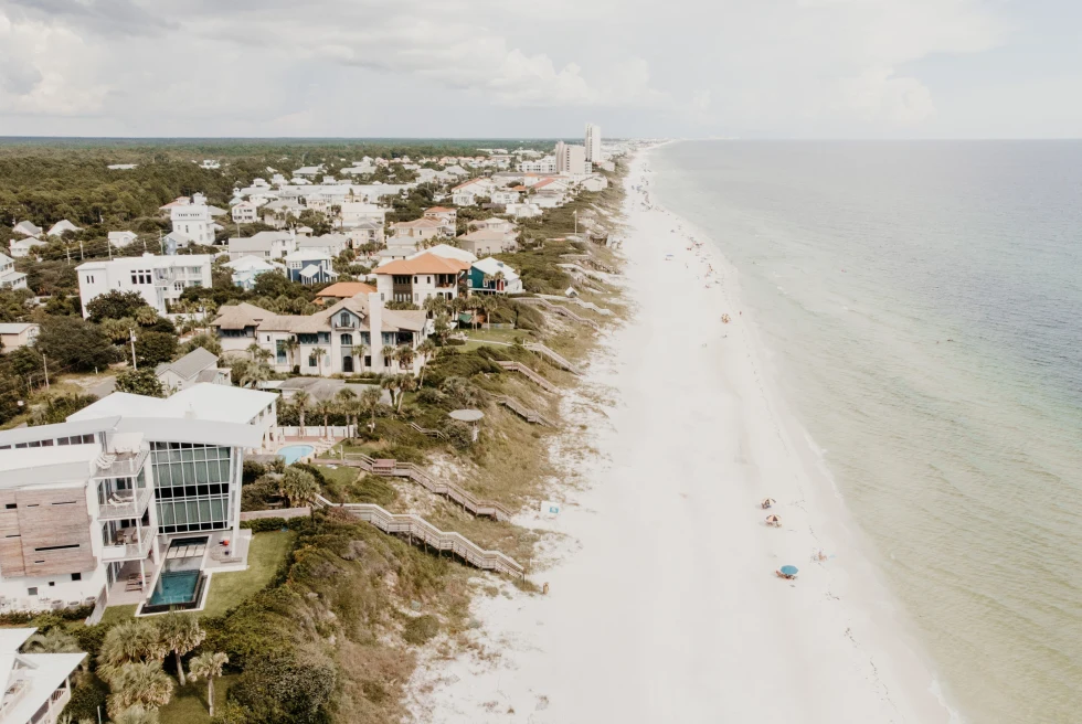 Aerial view of houses, sand and water in 30A florida