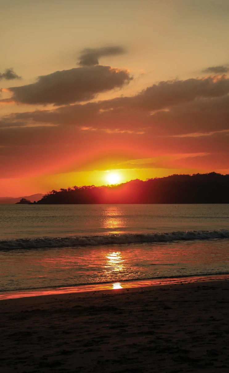 vibrant orange sunset over a calm beach 