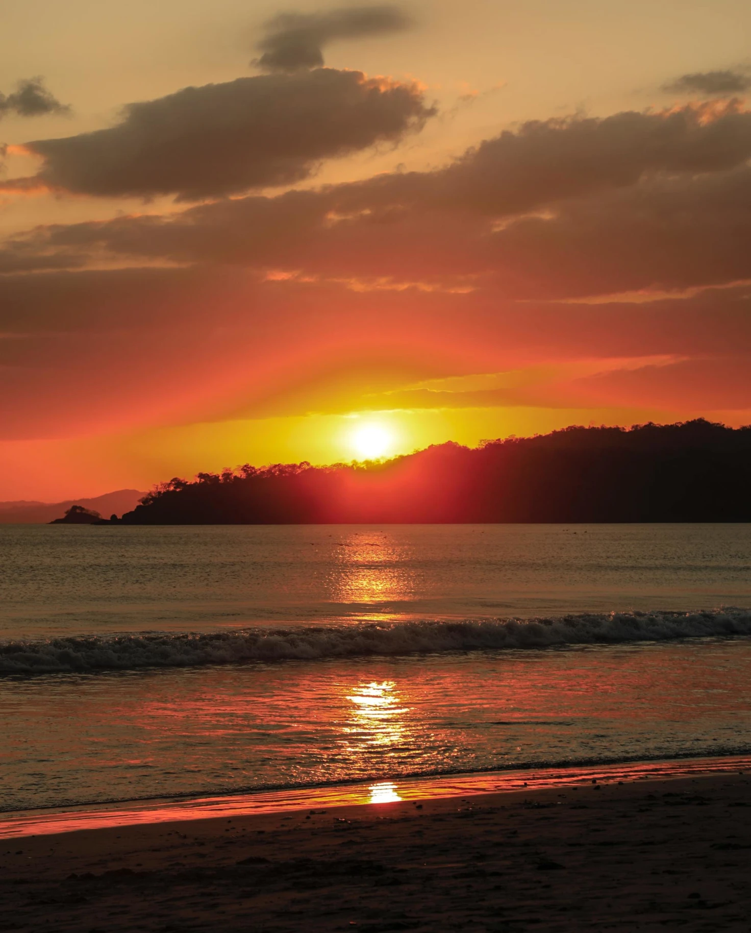 vibrant orange sunset over a calm beach 