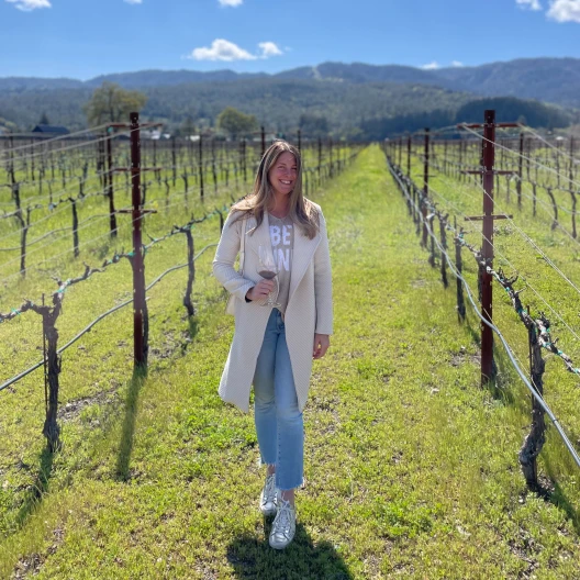 Travel advisor posing at a vineyard 