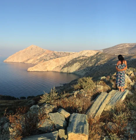 travel advisor Daphne Lin stands on top of a island cliff