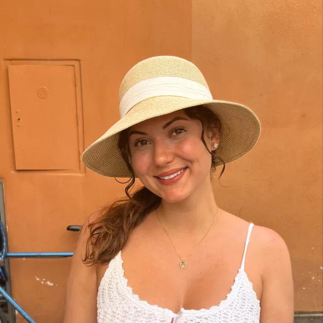 Travel Advisor Alicia Mayer in white top and a beige and white hat. 