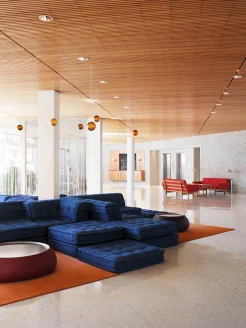 eclectic, modern lobby with navy couch and orange accents