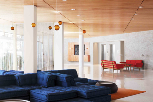 eclectic, modern lobby with navy couch and orange accents