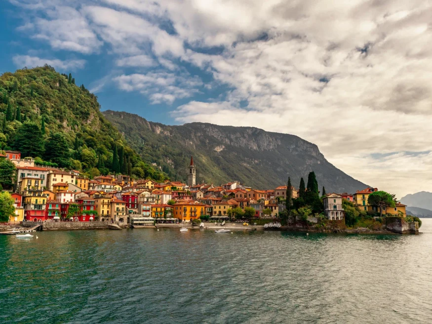 Colorful buildings next to water in Lake Como in Italy.