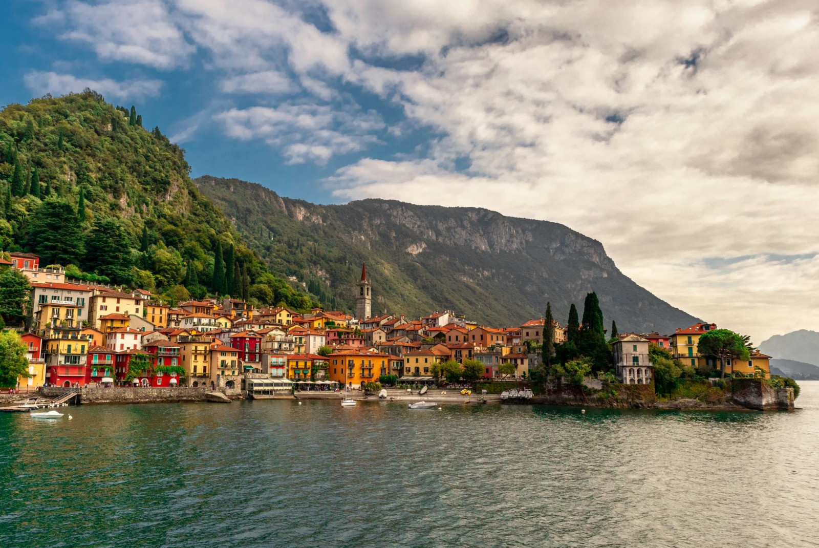 Colorful buildings next to water in Lake Como in Italy.
