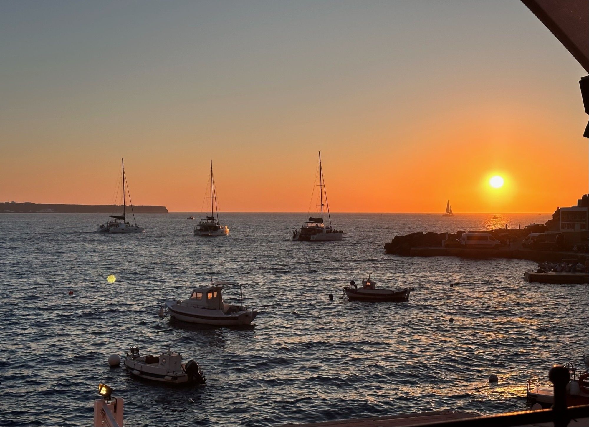 Sunset on an ocean with boats. 