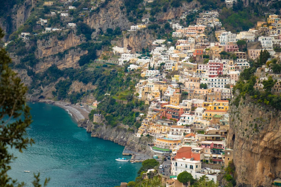 Aerial view of buildings on a cliffside by the ocean.