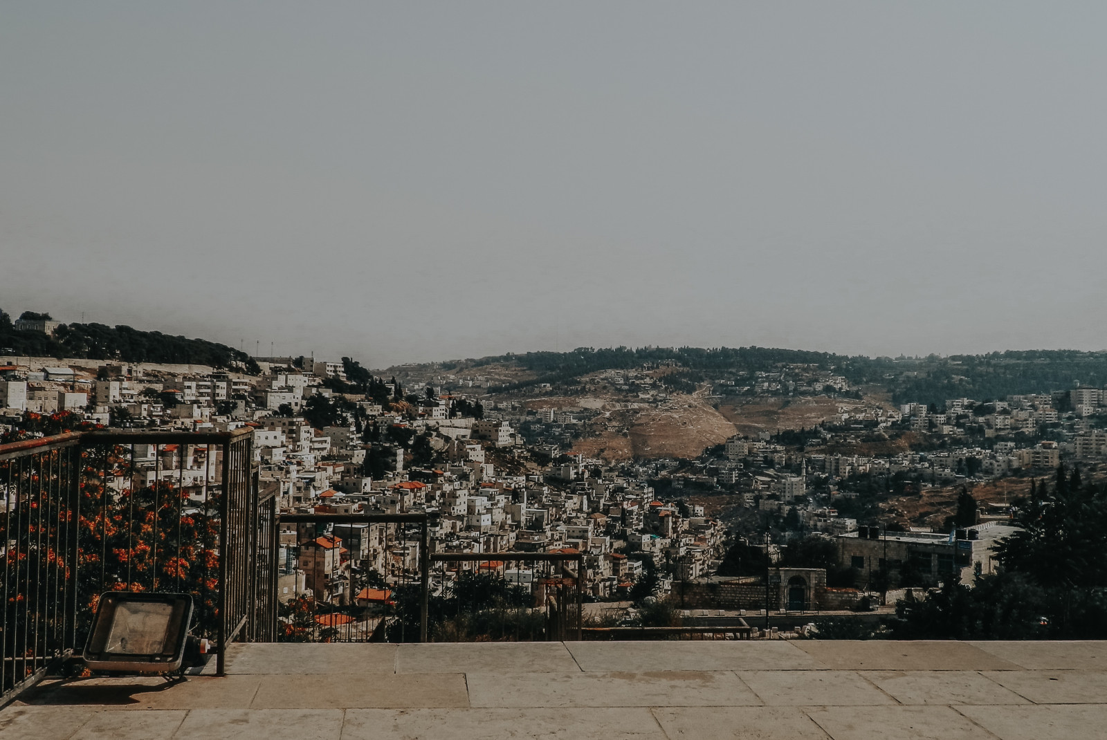 balcony overlooking hill with buildings