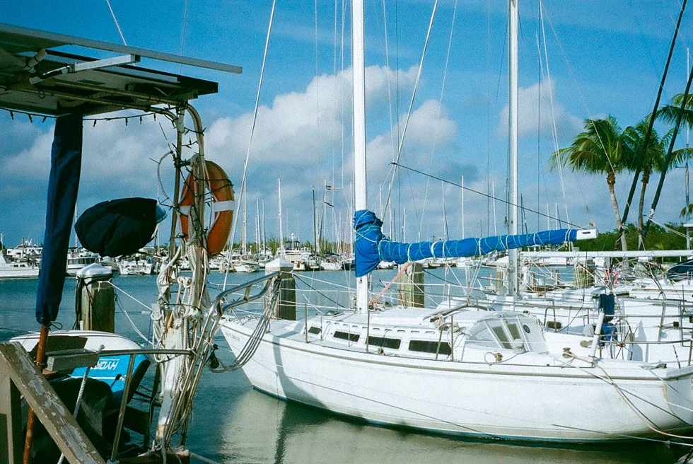 White boat in water with sunny skies during daytime