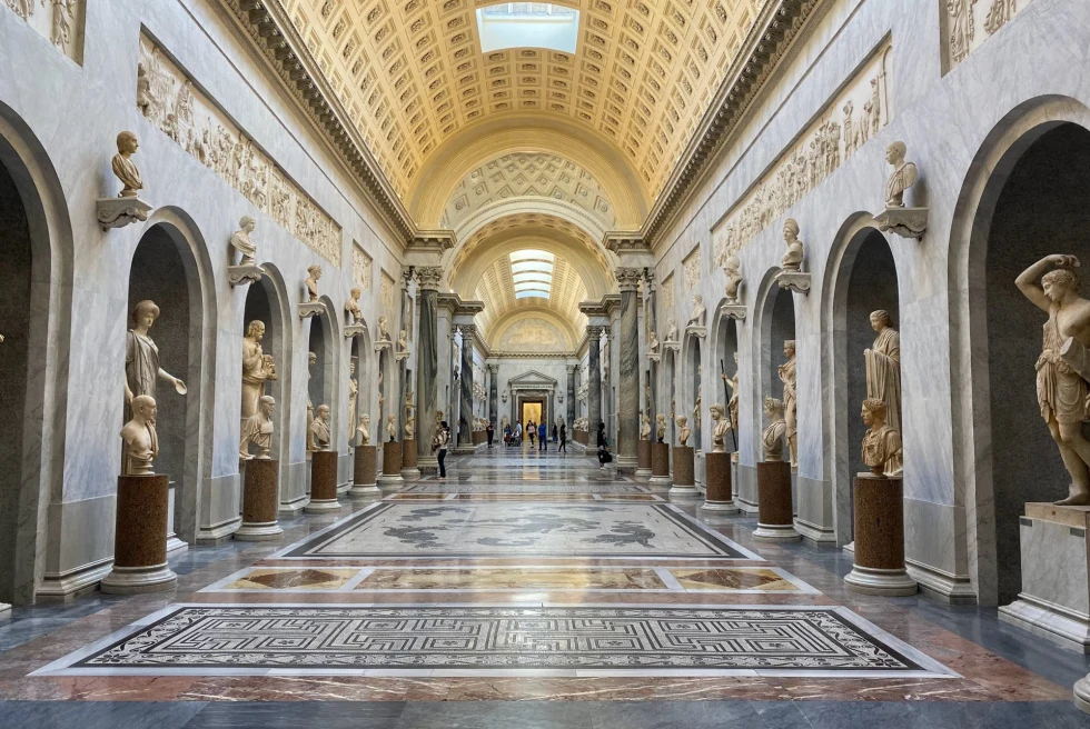 hall of a museum with ornate tile and sculptures lining the walls 