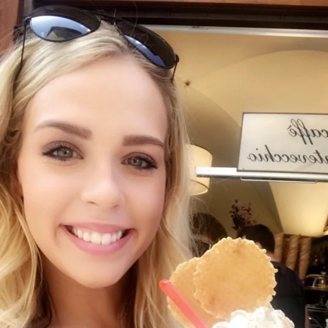 Travel Advisor Brittany Scheer smiles while holding a milkshake.