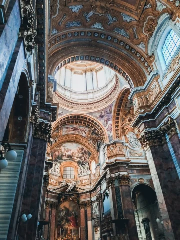 The image depicts the majestic interior of a cathedral, complete with elaborate artwork and architectural designs, bathed in ethereal light.